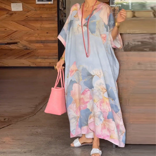 Loose, long dress with floral pattern and half-length sleeves